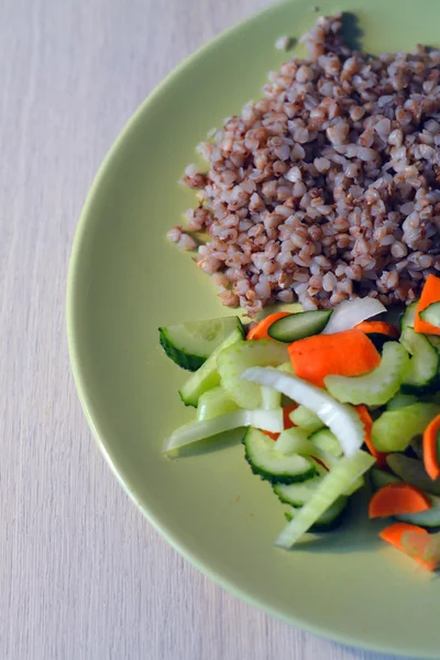 Buckwheat with fresh vegetable salad on a plate — Stock Photo, Image