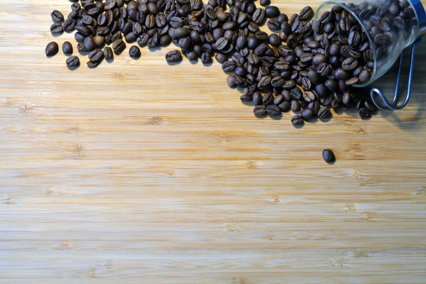 Coffee beans  spilled out of a glass cup — Stock Photo, Image