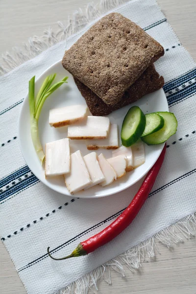 Snack of fresh lard, bread, green onion and cucumber — Stock Photo, Image