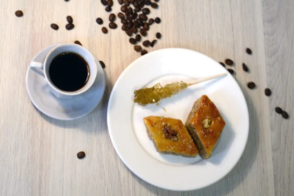 Cup of coffee with baklava and sugar stick — Stock Photo, Image