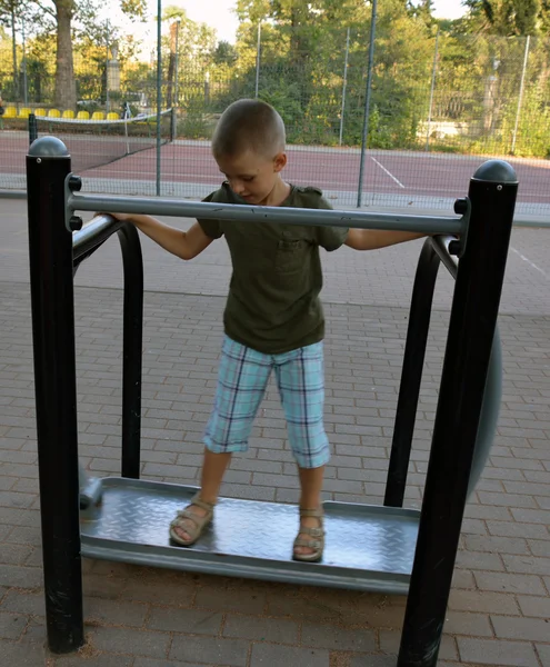 A boy training in the summer park — Stock Photo, Image