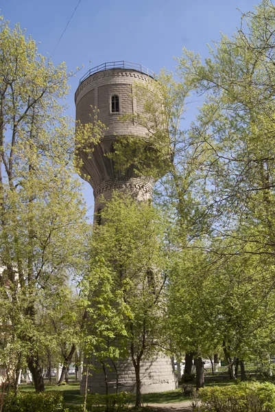 Torre de água velha com árvores — Fotografia de Stock