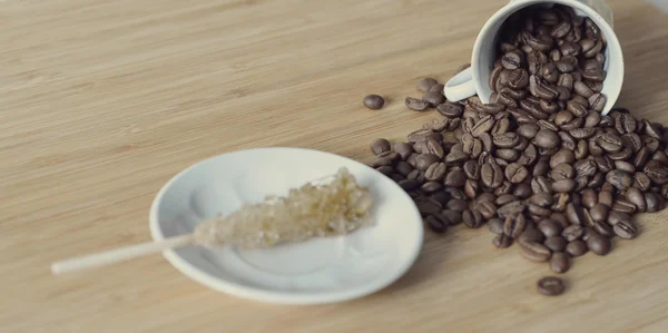 Coffee beans and a sugar stick — Stock Photo, Image