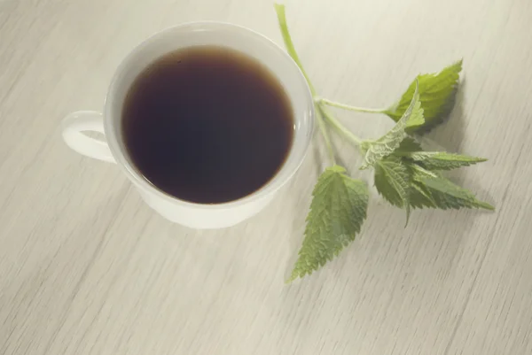 Cup of nettle tea with fresh nettle — Stock Photo, Image