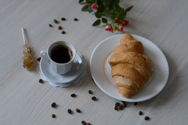 Café, un croixant et grains de café — Photo