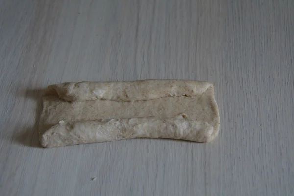 Piece of dough being rolled into ajarian khachapuri — Stock Photo, Image