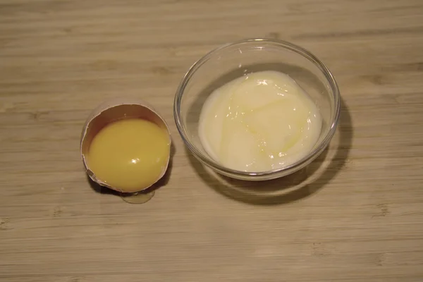 Facial cream and a yolk, on the table — Stock Photo, Image