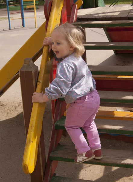 Happy toddler shouting on the wooden slide steps — Stock Photo, Image