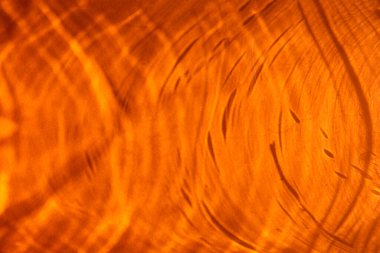 Yuvarlak gölgeler ve parıltılarla soyut turuncu arkaplan 