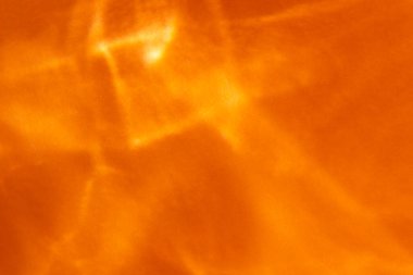 Gölgeler ve parıltılarla soyut turuncu arkaplan 