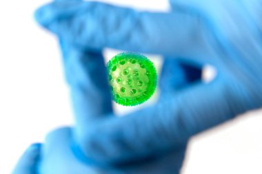 Elleri tıbbi eldivenlerde, virüsü kontrol ediyor. Covid-19 kafeste kontrol ediliyor.