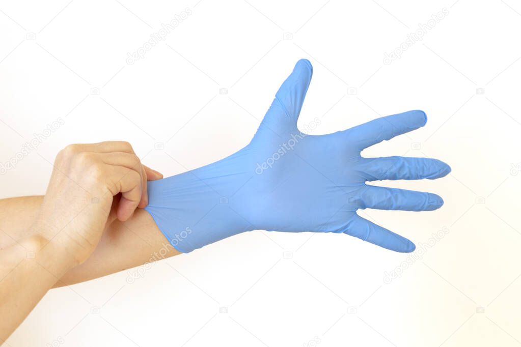 Woman puts on sterile medical gloves