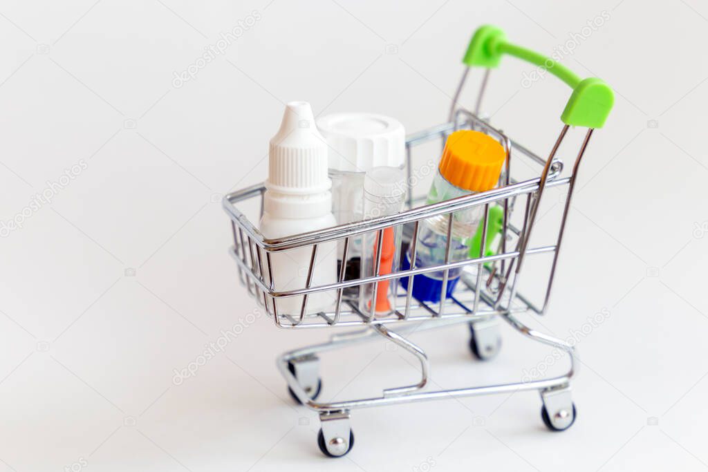 Shopping trolley with equipment for overnight vision correction: eye drops, container, lenses