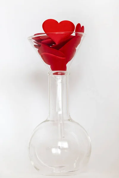 Funnel with red hearts is recycled into a flask