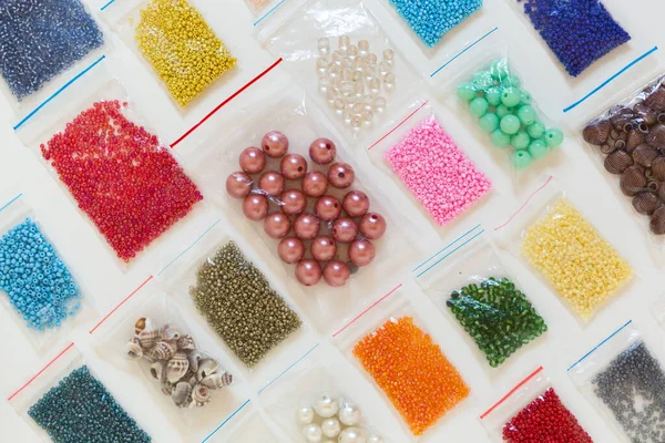 Colored packed beads laid out i as a background. Creative flat lay for beading handcrafters