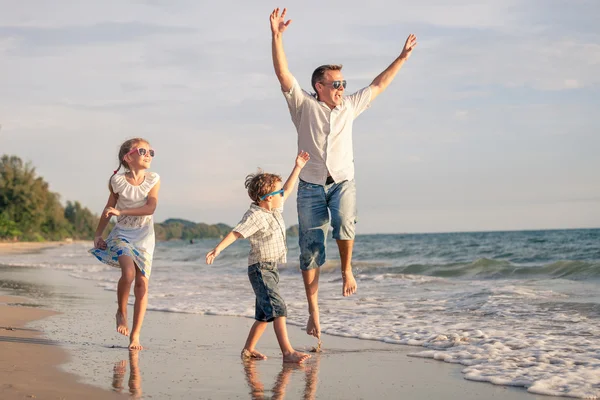 Padre e hijos jugando en la costa del lago — Foto de Stock