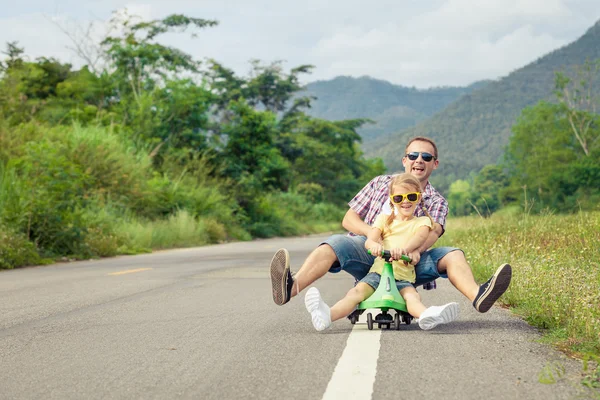 Father and daughter playing  on the road at the day time. — Stock Photo, Image