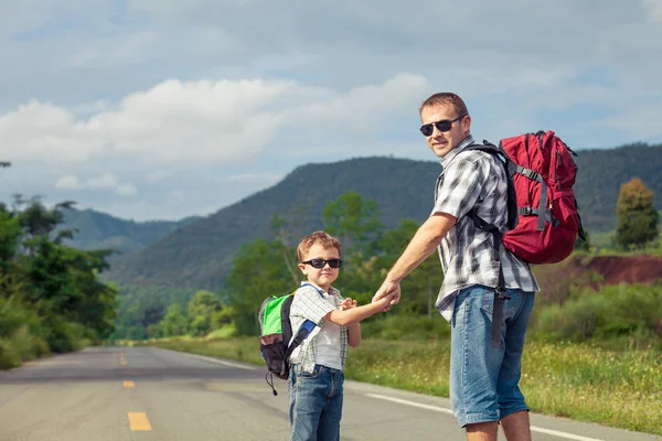 Father and son walking on the road at the day time. — Stock Photo, Image