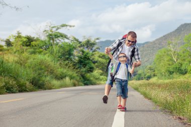 Baba ve oğul gün zaman yolda yürürken.