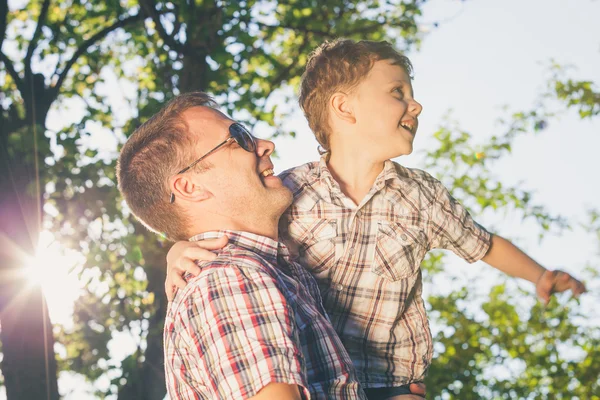 Father and son playing at the park at the day time. Stock Photo