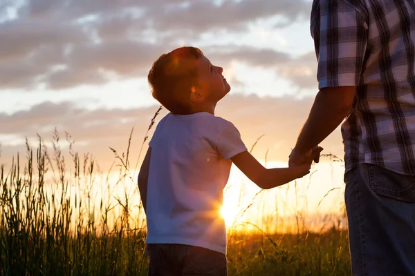 Father and son playing at the park at the sunset time. — Stock Photo, Image