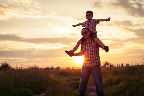 Father and son playing at the park at the sunset time. — Stock Photo, Image