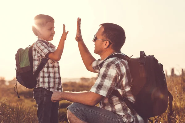 Father and son playing in the park at the sunset time. — Stock Photo, Image