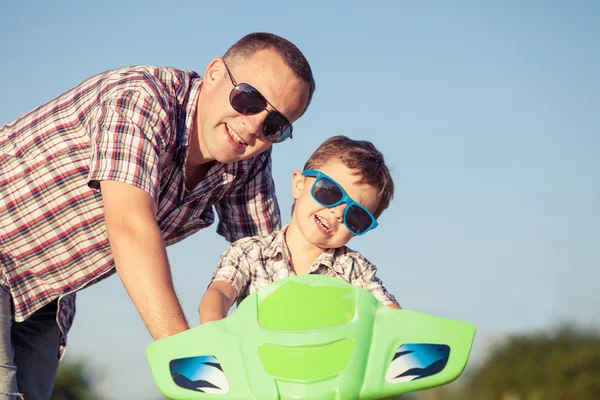 Father and son playing on the road at the day time. — Stock Photo, Image