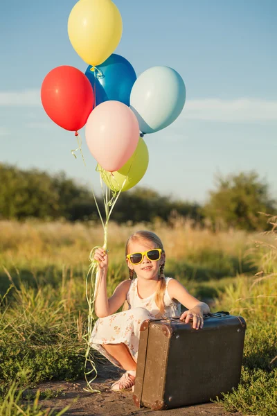 Gelukkig klein meisje spelen op weg op het moment van de dag. — Stockfoto