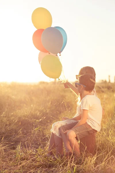 Happy child playing on the field at the sunset time. — Stock Photo, Image