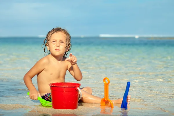 Menino brincando na praia na hora do dia — Fotografia de Stock