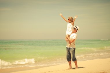 Baba ve kızı kumsalda gün anda oynamak