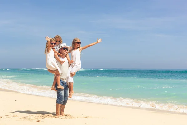 Happy family playing at the beach in the day time — Stock Photo, Image