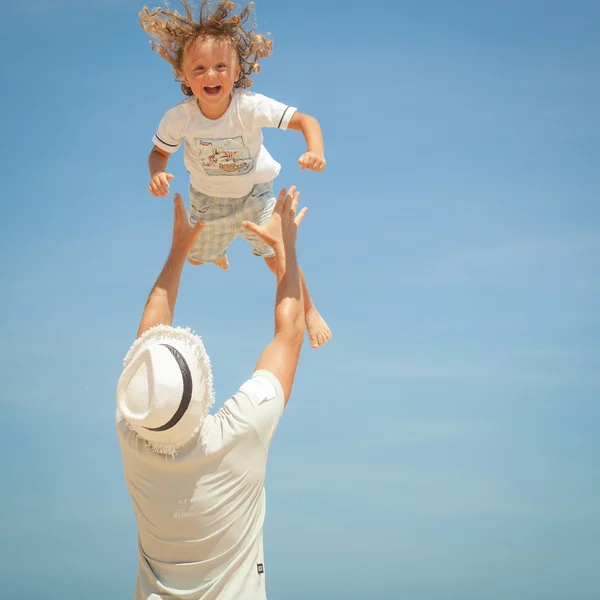 Father and son playing on the beach at the day time — Stock Photo, Image