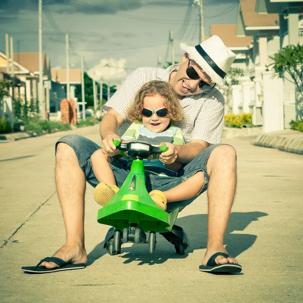 Father and son playing near a house at the day time — Stock Photo, Image