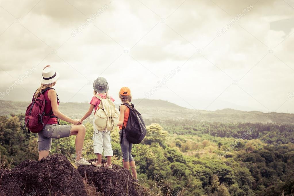 two little kids and mother in the mountains