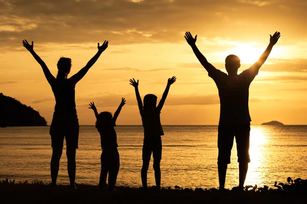 Silhouette of happy family who playing on the beach at the suns Royalty Free Stock Images