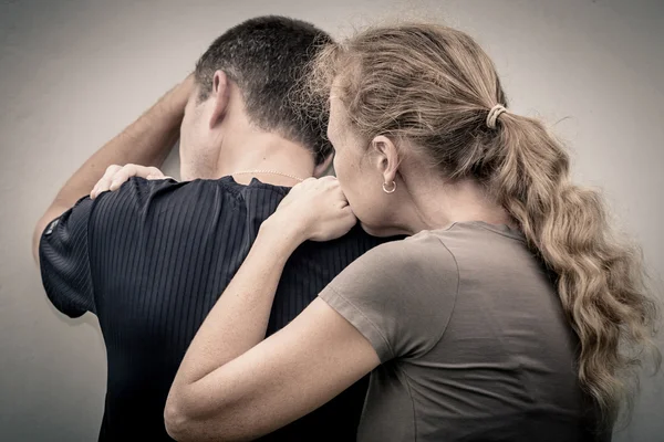 Sad woman hugging her husband — Stock Photo, Image