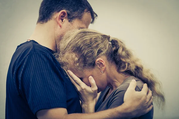 Sad woman hugging her husband — Stock Photo, Image