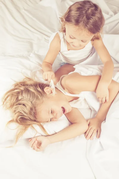 Lovely brother and sister lying in bed at home — Stock Photo, Image