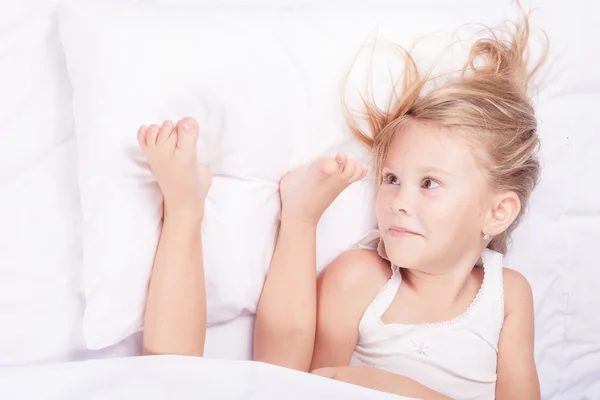 Lovely little girl lying in bed at home — Stock Photo, Image