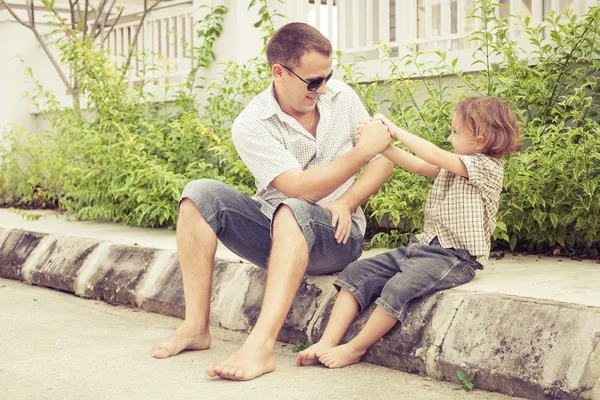 Papà e figlio giocano vicino a una casa — Foto Stock