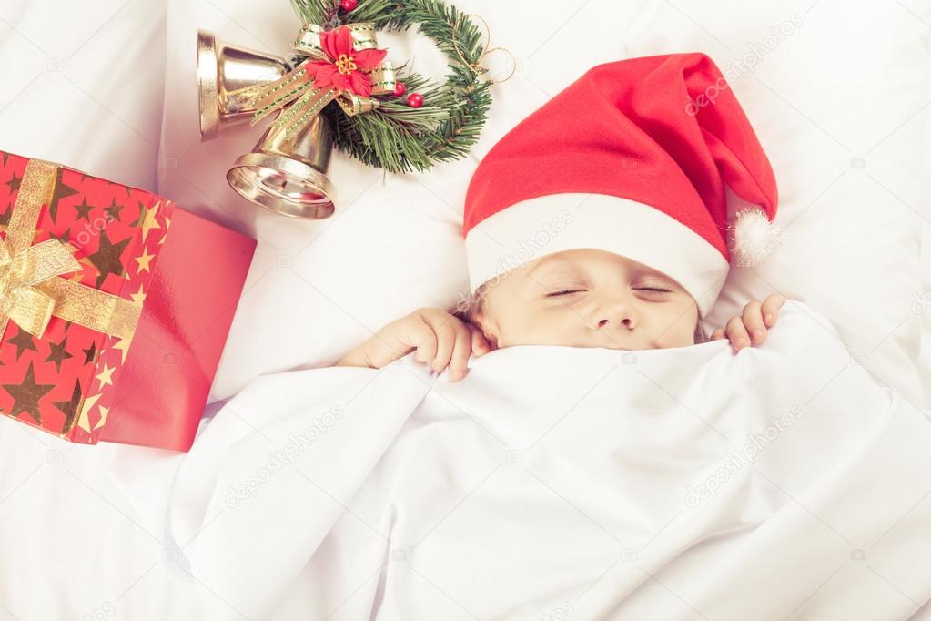 Lovely little boy lying in bed at home