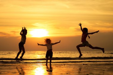 Kumsalda oynayan mutlu çocuklar