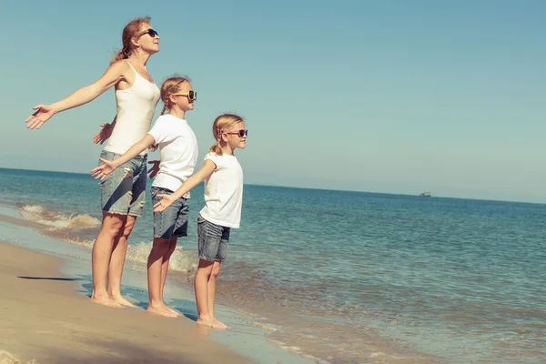 Mother and daughters  playing on the beach at the day time. — Stock Photo, Image