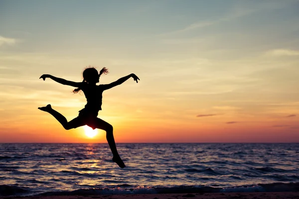Happy girl jumping on the beach Stock Photo