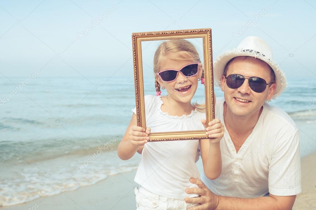 Father and daughter playing on the beach.