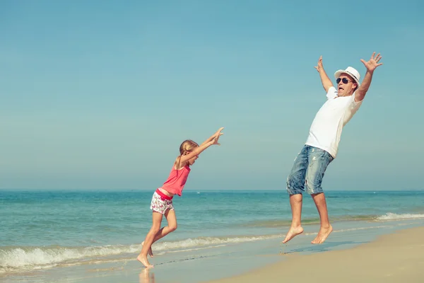 Father and daughter playing on the beach at the day time. Royalty Free Stock Photos