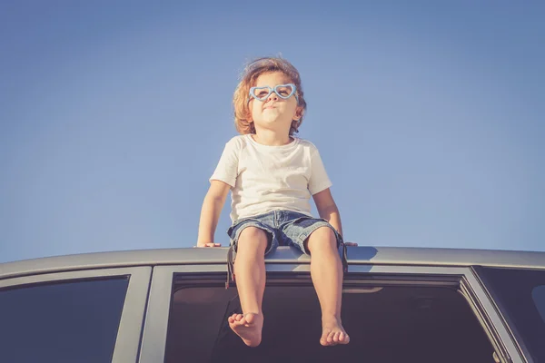 Happy little boy sitting in the car — Stock Photo, Image