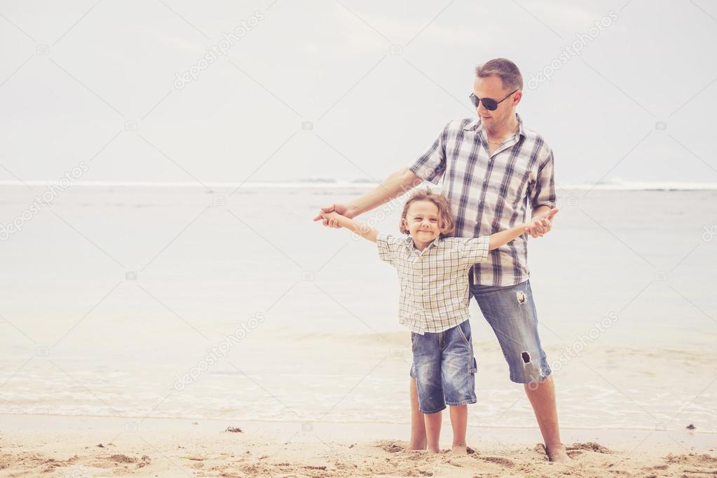 Father and son playing on the beach at the day time.